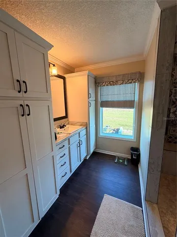 a view of hallway with stairs and wooden floor