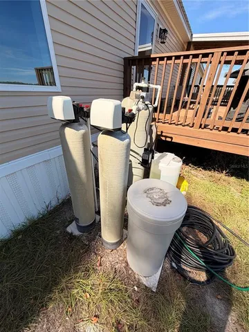 a lake view with a table and chairs with wooden fence