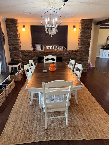 a view of a dining room with furniture wooden floor and chandelier