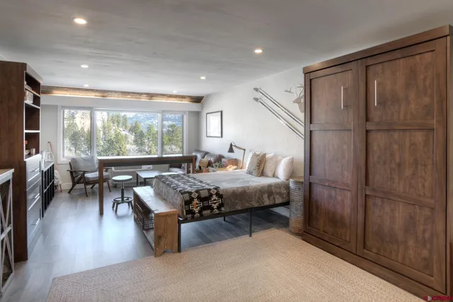 a bedroom with a bed and a large window