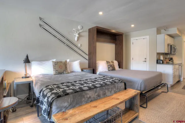 a bedroom with a bed and a lamp