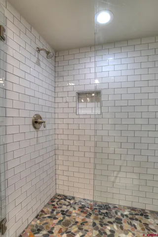 a front view of a building with lot of cars and trees