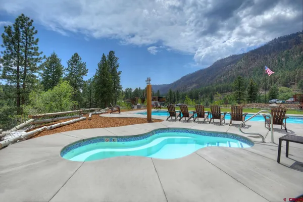 a view of a swimming pool with outdoor seating