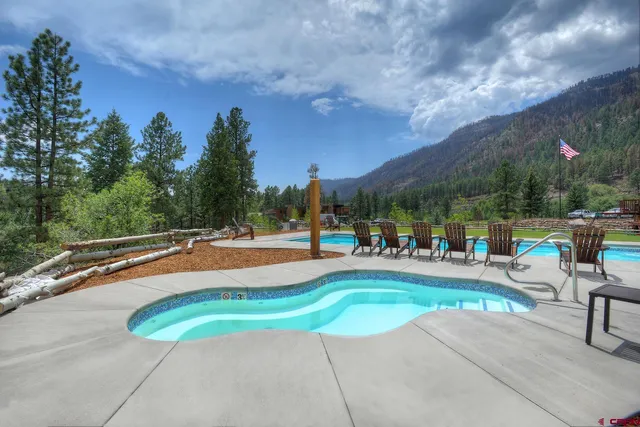 a view of a swimming pool with outdoor seating