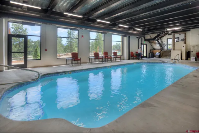 a view of swimming pool with trees in the background
