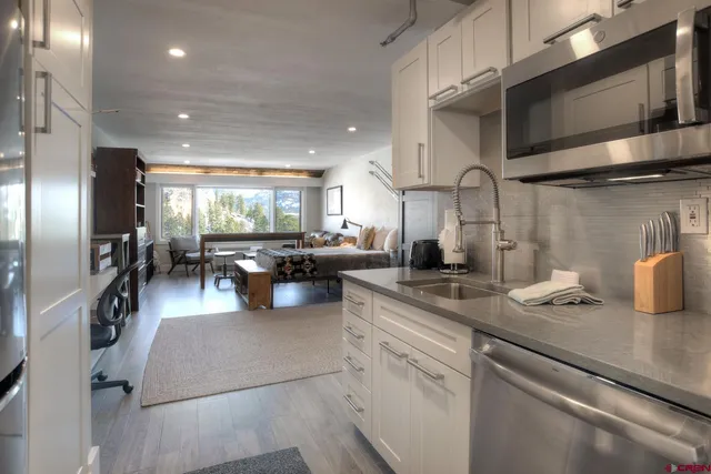 a kitchen with counter top space cabinets and stainless steel appliances