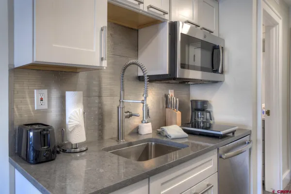 a kitchen with a sink and a microwave