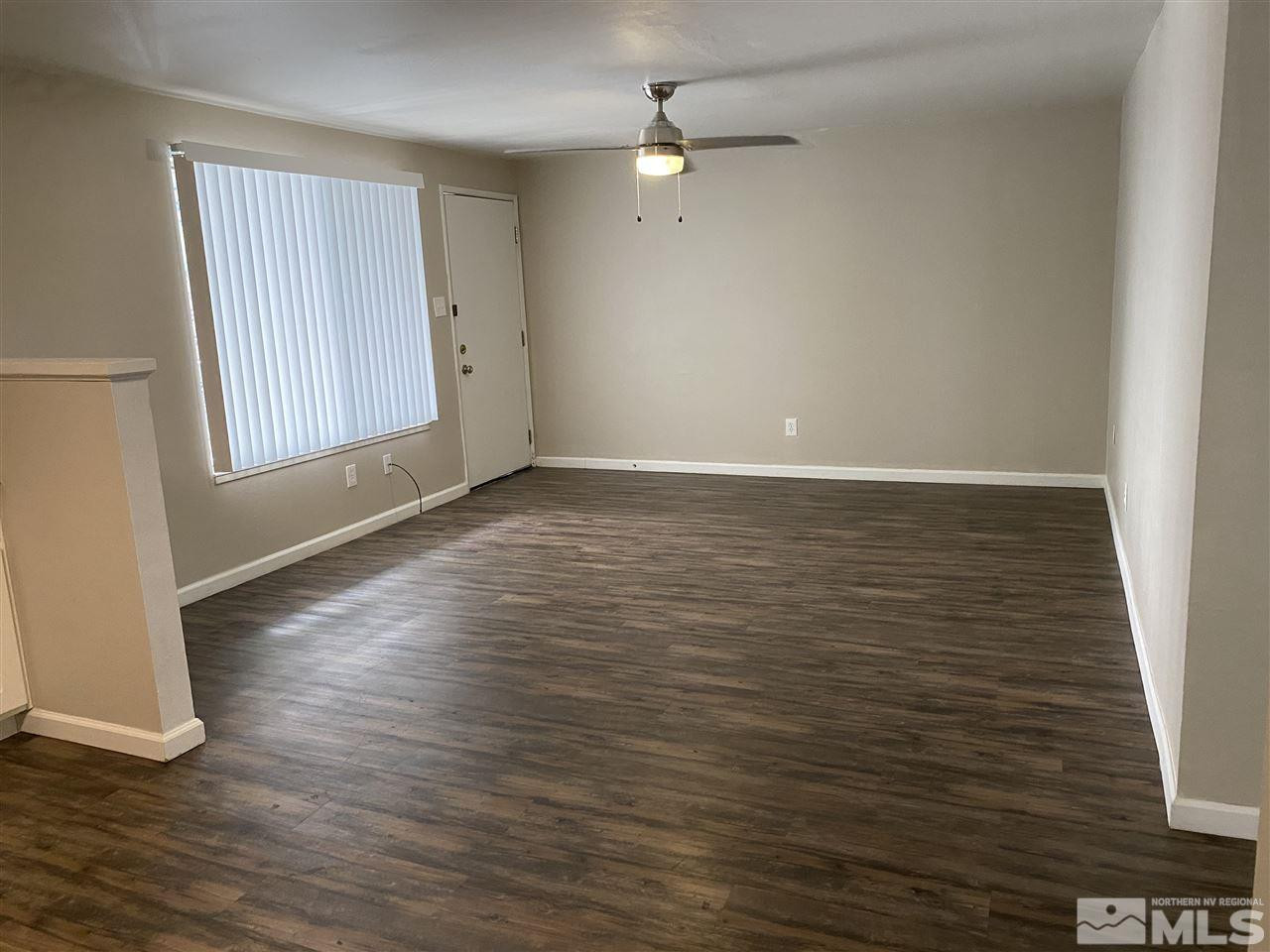 1365 Stardust Street, Unit 3 Reno, NV 89503 - Photo 3 of 9 wooden floor in an empty room with a window