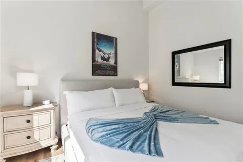 a bedroom with a bed and a painting on the wall