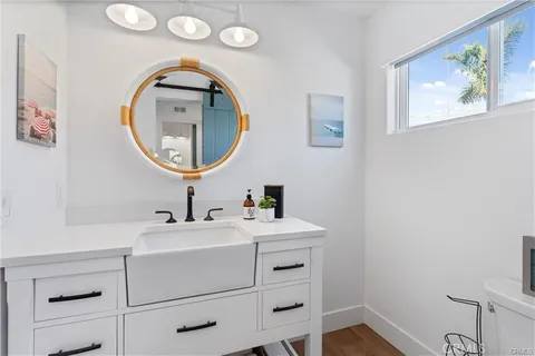a bathroom with a granite countertop shower a toilet and a sink