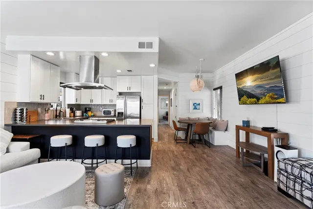 a living room with lots of furniture and kitchen view