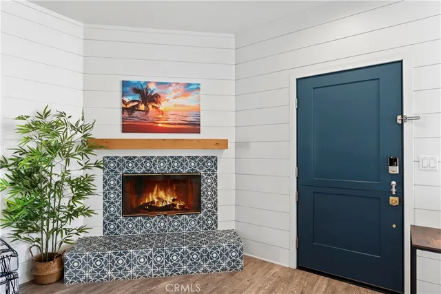 a living room with a fireplace and a potted plant