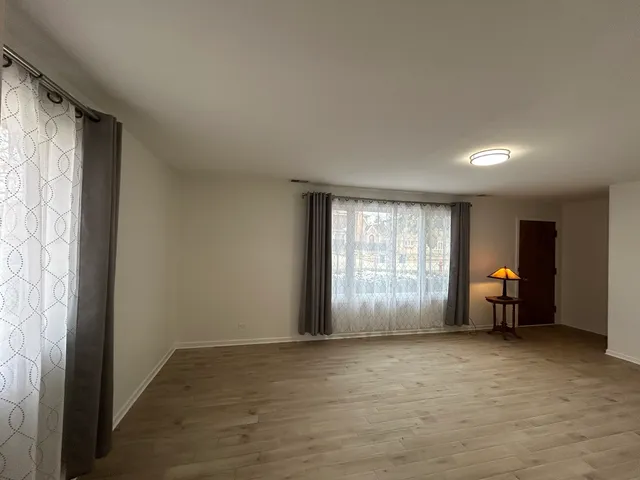 an empty room with furniture and windows