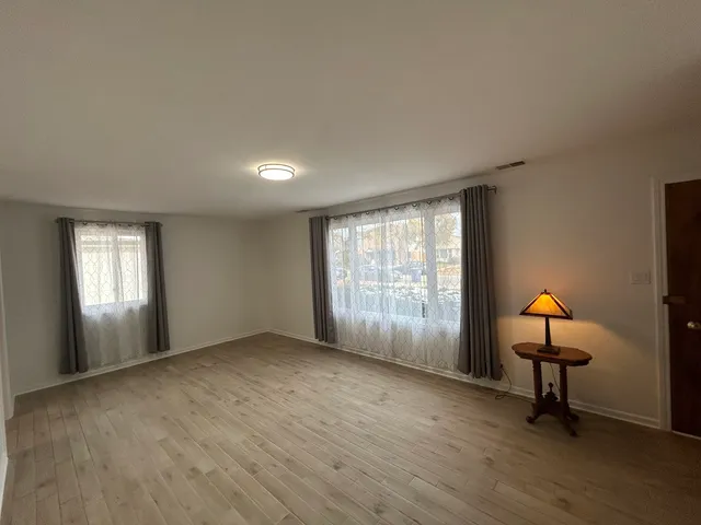 a view of a room with furniture wooden floor and a window