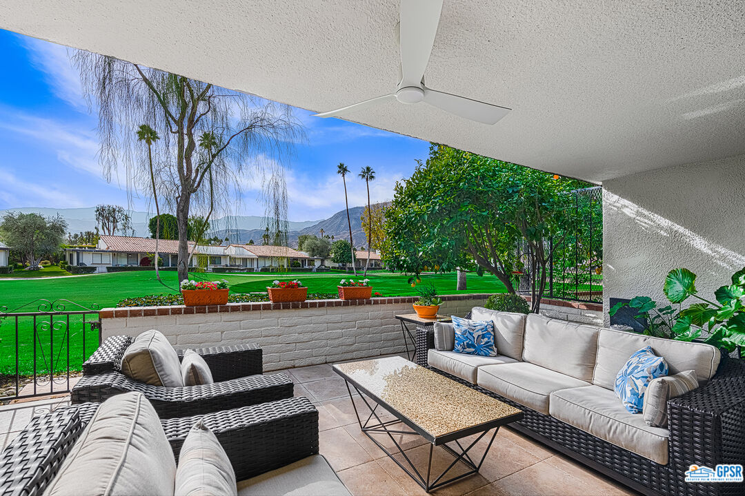 75 Durango Circle Rancho Mirage, CA 92270 - Photo 1 of 37 a view of a patio with couches table and chairs with wooden fence