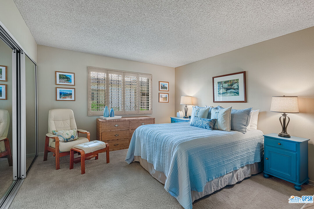 75 Durango Circle Rancho Mirage, CA 92270 - Photo 13 of 37 a bedroom with a bed and a couch