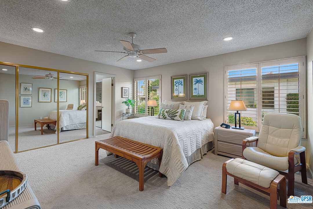 75 Durango Circle Rancho Mirage, CA 92270 - Photo 14 of 37 a spacious bedroom with a bed and a couch
