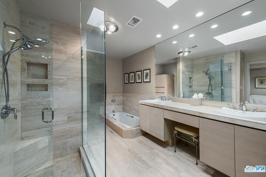 75 Durango Circle Rancho Mirage, CA 92270 - Photo 15 of 37 a bathroom with a double vanity sink a toilet and shower