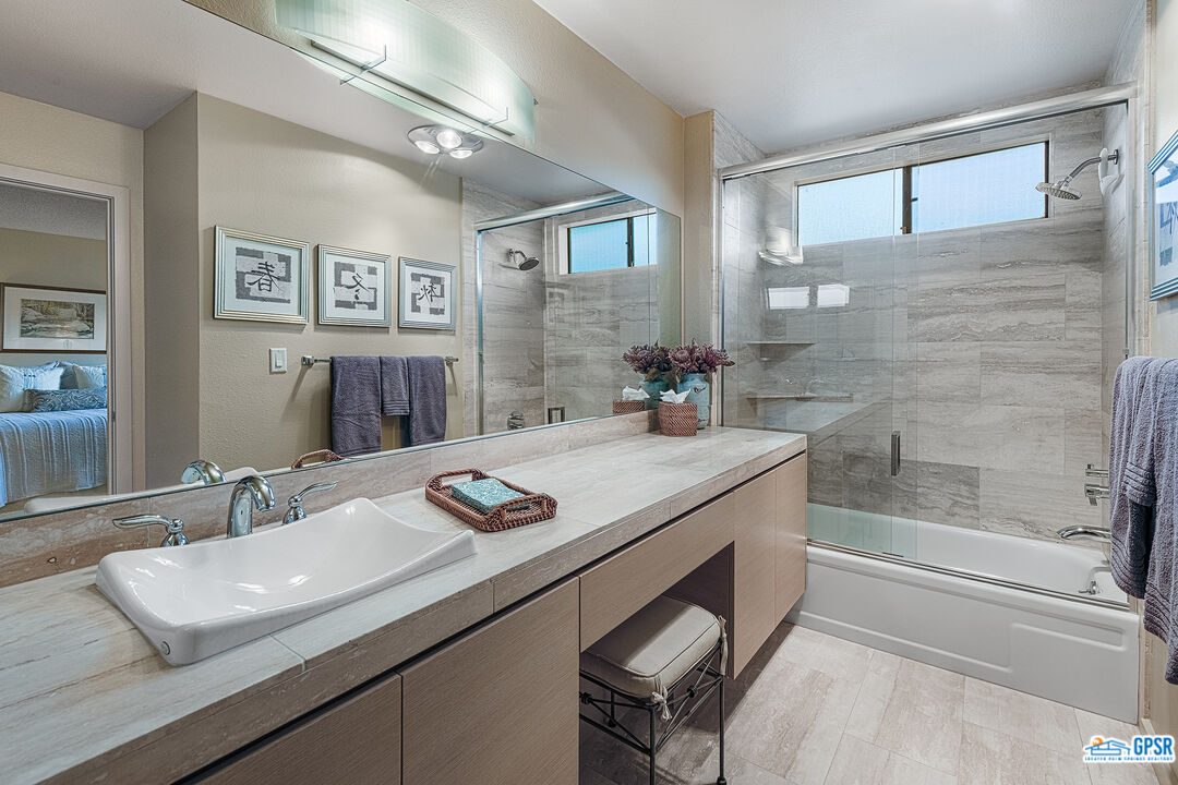 75 Durango Circle Rancho Mirage, CA 92270 - Photo 16 of 37 a bathroom with a granite countertop sink a mirror and a bathtub
