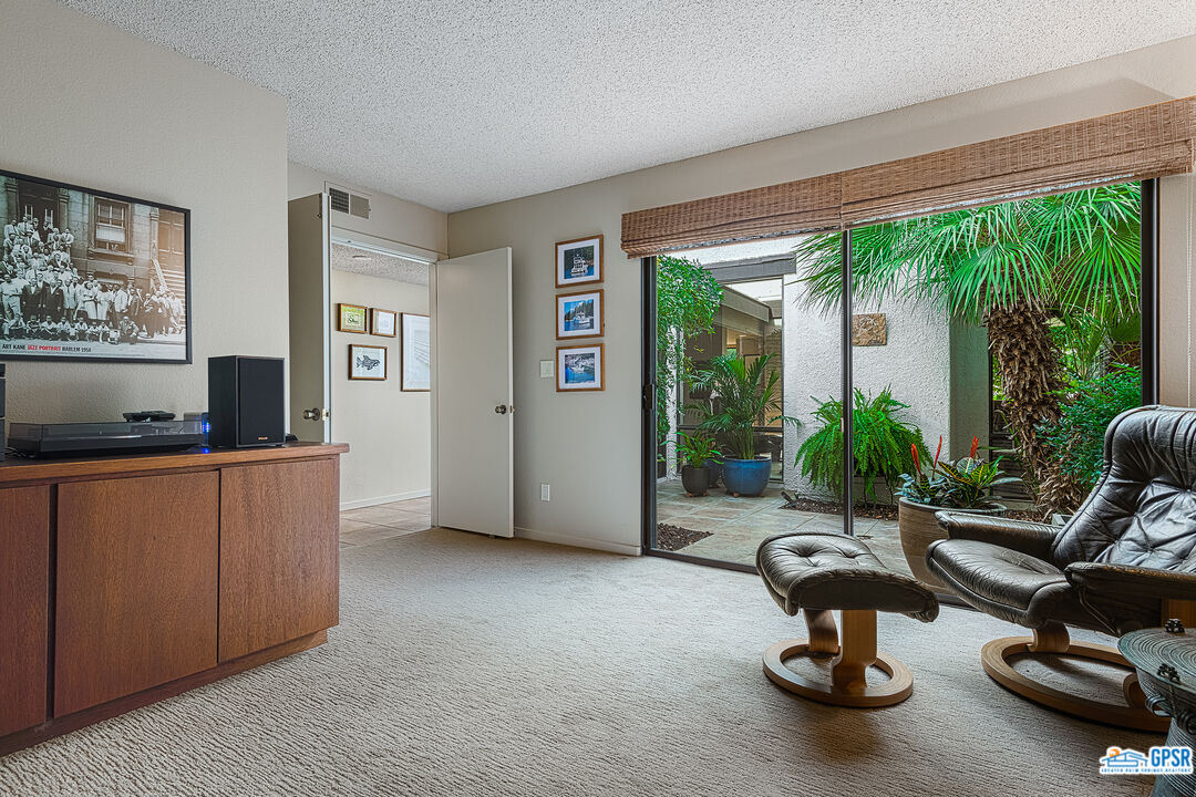 75 Durango Circle Rancho Mirage, CA 92270 - Photo 17 of 37 a living room with furniture a window and a flat screen tv
