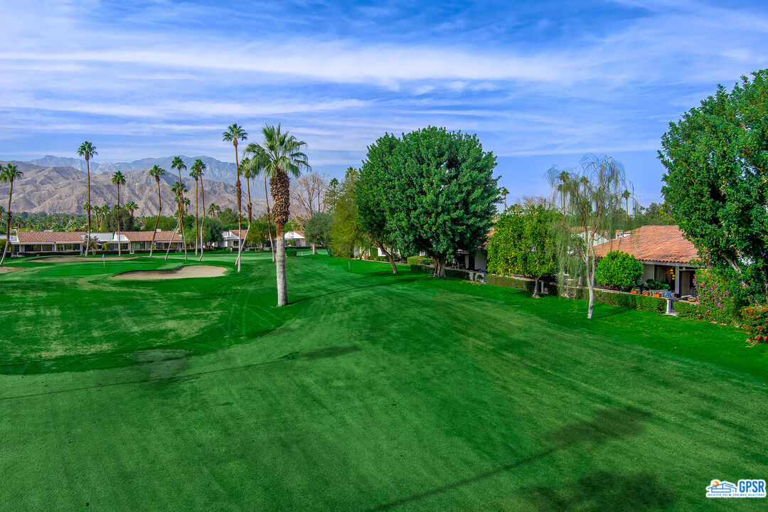 75 Durango Circle Rancho Mirage, CA 92270 - Photo 21 of 37 a view of a garden with a building in the background