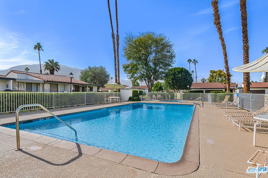 75 Durango Circle Rancho Mirage, CA 92270 - Photo 28 of 37 a view of a swimming pool with a lounge chairs
