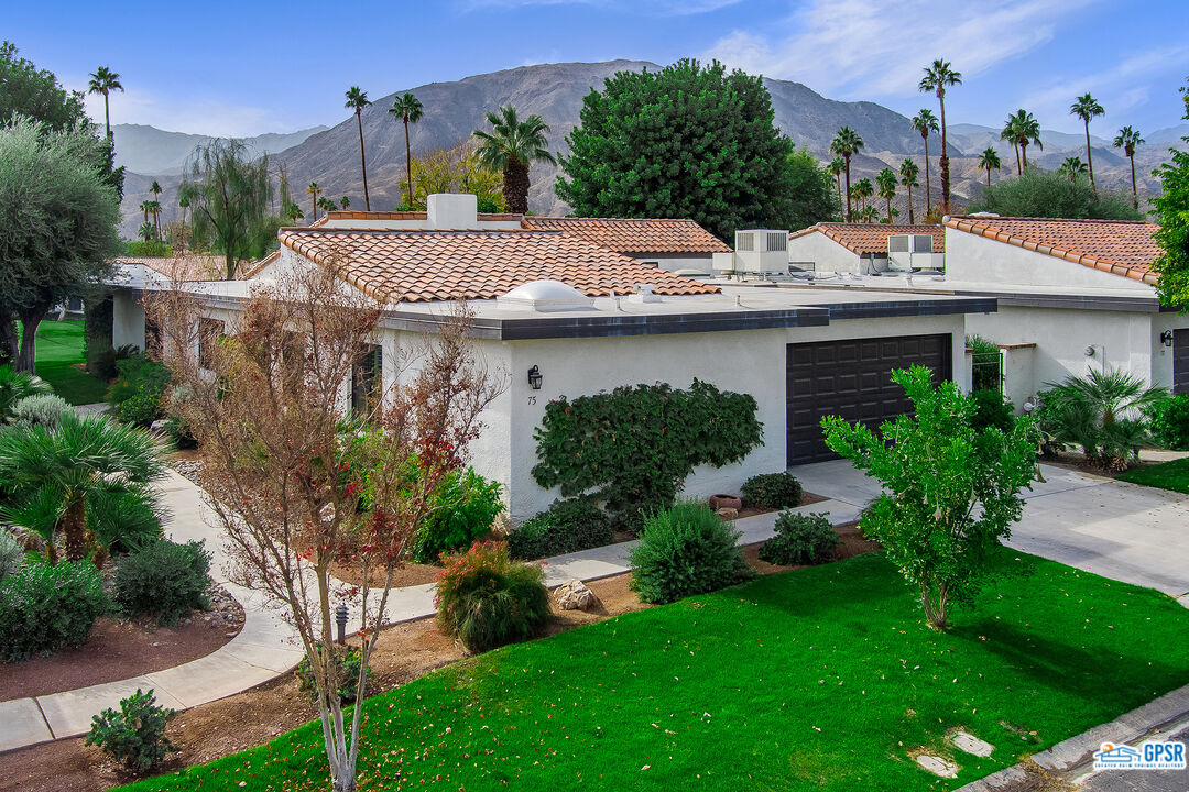 75 Durango Circle Rancho Mirage, CA 92270 - Photo 3 of 37 a view of a house with a yard and plants