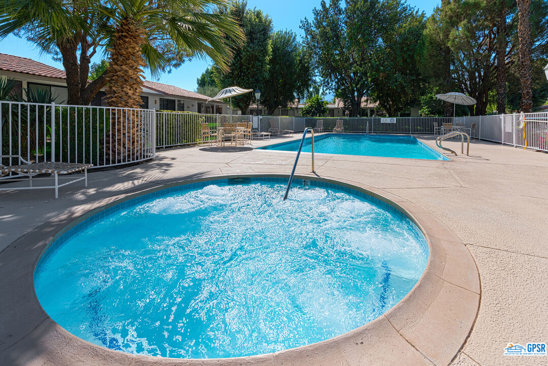 75 Durango Circle Rancho Mirage, CA 92270 - Photo 31 of 37 a view of a swimming pool with an outdoor seating