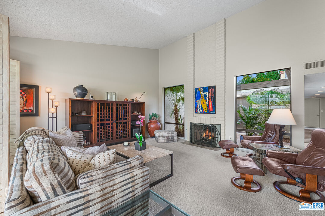 75 Durango Circle Rancho Mirage, CA 92270 - Photo 6 of 37 a living room with furniture and a fireplace