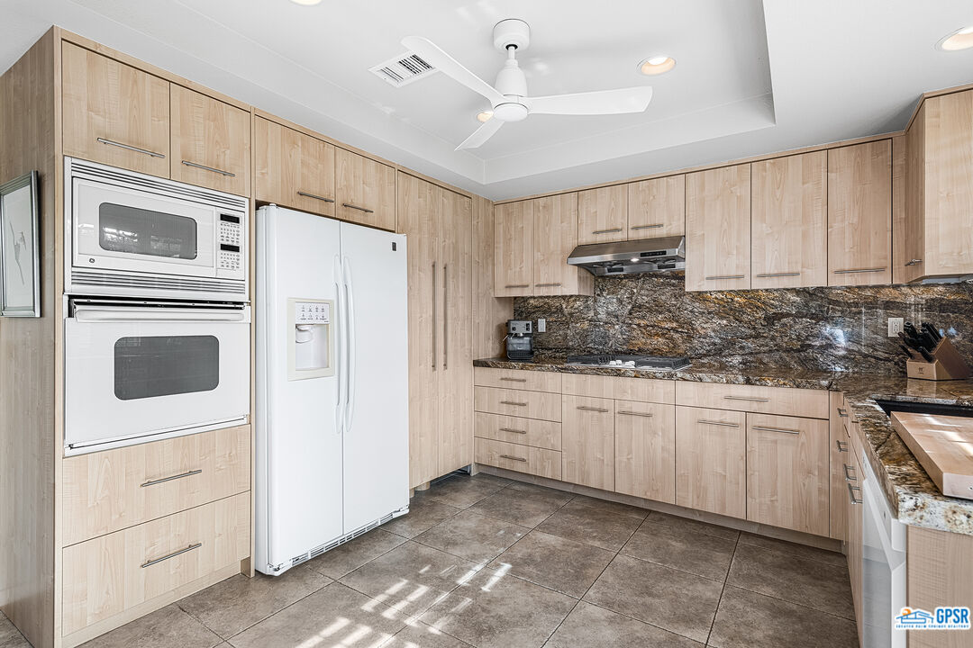 75 Durango Circle Rancho Mirage, CA 92270 - Photo 10 of 37 a kitchen with stainless steel appliances granite countertop a refrigerator sink and cabinets