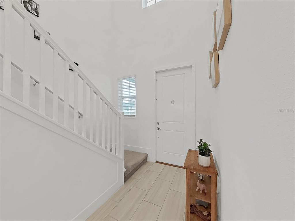 8312 Rolling Tides Drive New Port Richey, FL 34655 - Photo 16 of 49 a view of entryway with lots of frames on wall and wooden floor