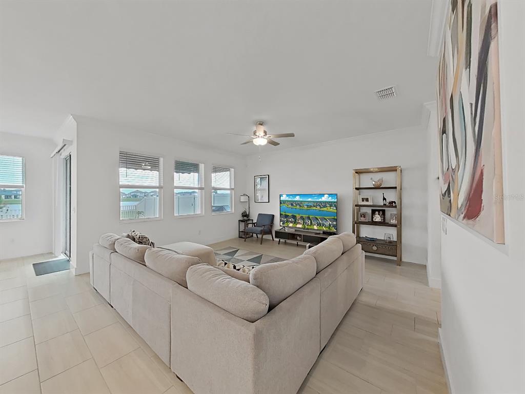 8312 Rolling Tides Drive New Port Richey, FL 34655 - Photo 21 of 49 a living room with furniture and a flat screen tv