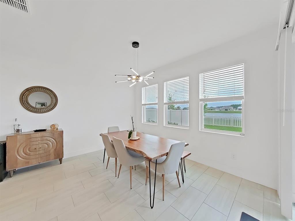 8312 Rolling Tides Drive New Port Richey, FL 34655 - Photo 22 of 49 a view of a dining room that has a table and chairs in it