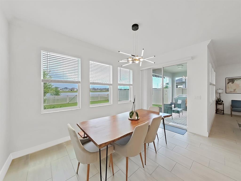8312 Rolling Tides Drive New Port Richey, FL 34655 - Photo 23 of 49 a view of a dining room with furniture and chandelier