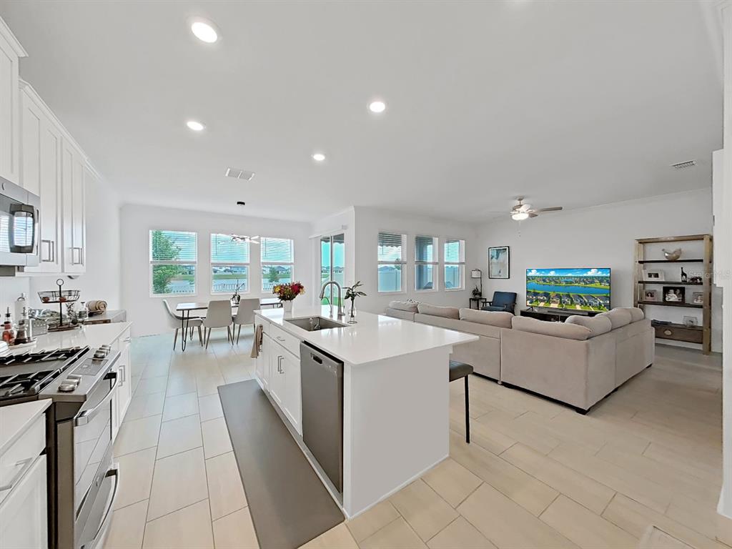 8312 Rolling Tides Drive New Port Richey, FL 34655 - Photo 26 of 49 a living room with stainless steel appliances furniture a rug kitchen view and a counter top space