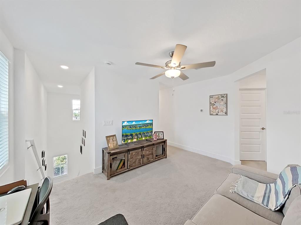 8312 Rolling Tides Drive New Port Richey, FL 34655 - Photo 30 of 49 a living room with furniture and a chandelier
