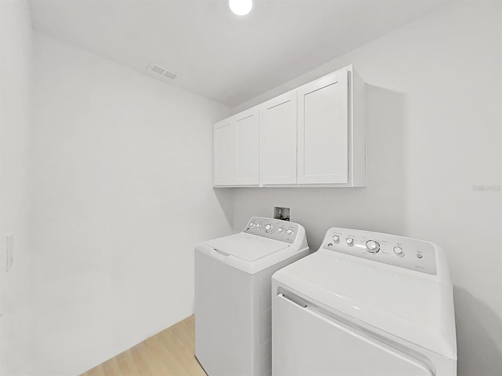 8312 Rolling Tides Drive New Port Richey, FL 34655 - Photo 32 of 49 a utility room with dryer and washer