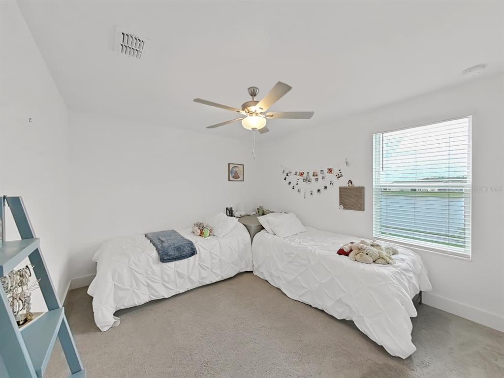 8312 Rolling Tides Drive New Port Richey, FL 34655 - Photo 35 of 49 a bed room with bed and a window
