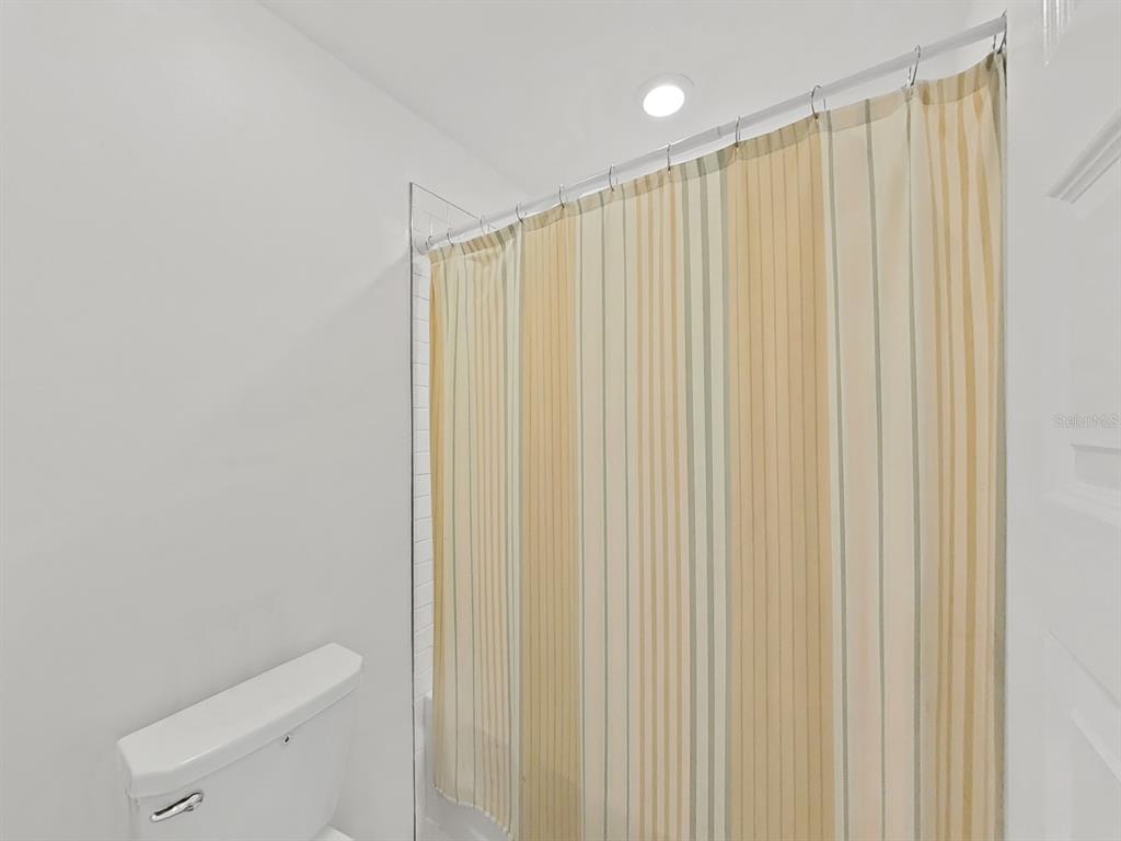 8312 Rolling Tides Drive New Port Richey, FL 34655 - Photo 39 of 49 a bathroom with a shower curtain and sink
