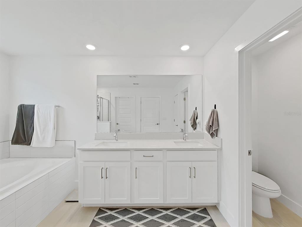 8312 Rolling Tides Drive New Port Richey, FL 34655 - Photo 48 of 49 a bathroom with a sink a toilet and a tub
