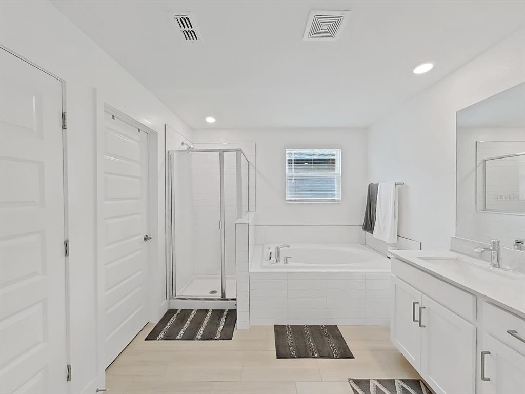 8312 Rolling Tides Drive New Port Richey, FL 34655 - Photo 49 of 49 a bathroom with a sink a toilet a tub and shower