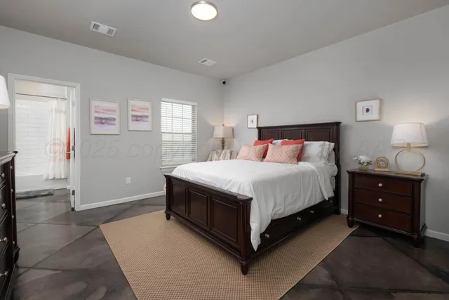 a bedroom with a bed and window