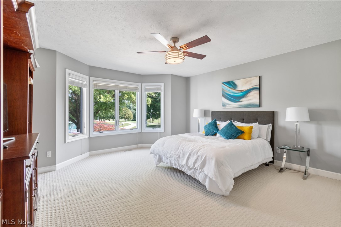 7300 Branch Road Medina, OH 44256 - Photo 21 of 34 Bedroom featuring a textured ceiling, ceiling fan, and light colored carpet