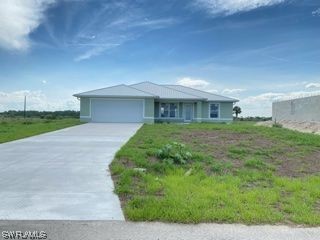 630 Royce Road LaBelle, FL 33935 - Photo 1 of 9 a front view of a house with garden