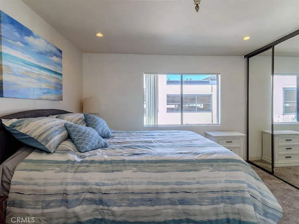 18900 Delaware Street Huntington Beach, CA 92648 - Photo 13 of 21 a bedroom with a large bed and a window
