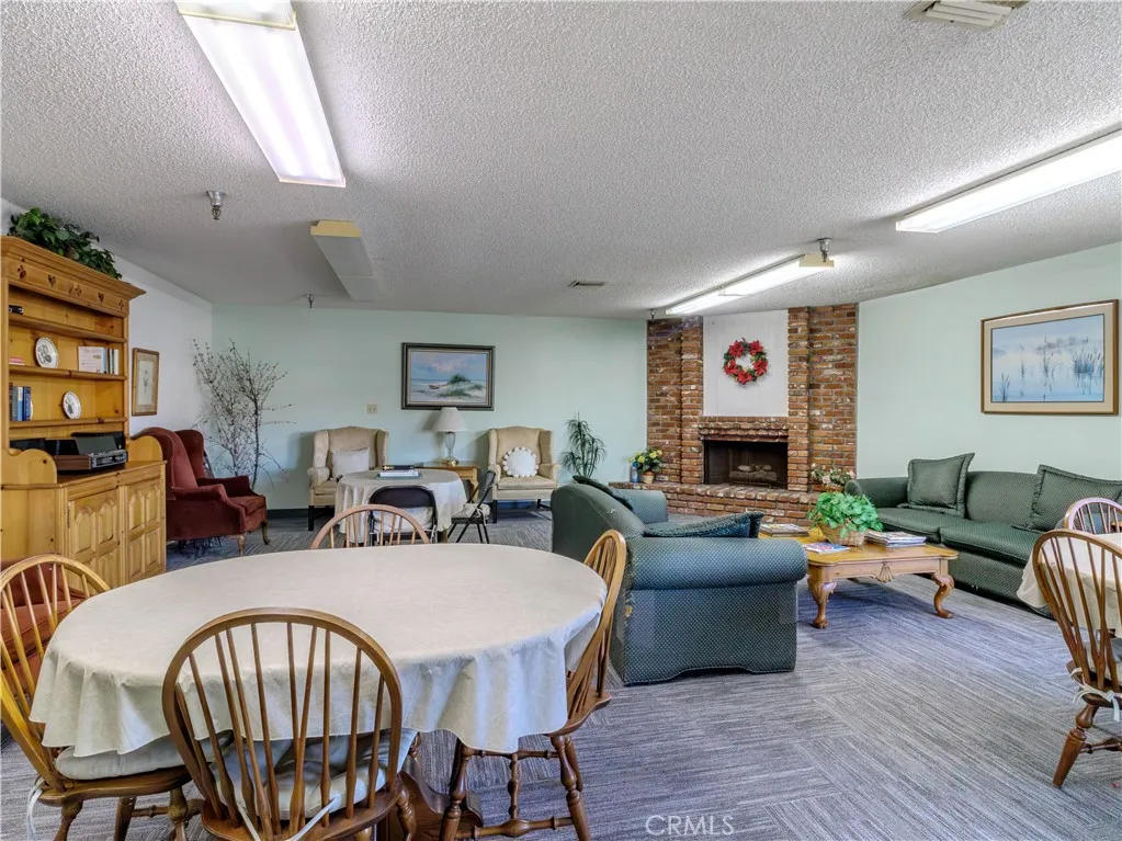 18900 Delaware Street Huntington Beach, CA 92648 - Photo 15 of 21 a living room with furniture a fireplace and a flat screen tv