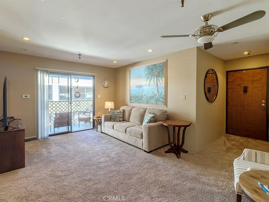 18900 Delaware Street Huntington Beach, CA 92648 - Photo 5 of 21 a living room with furniture and a large window