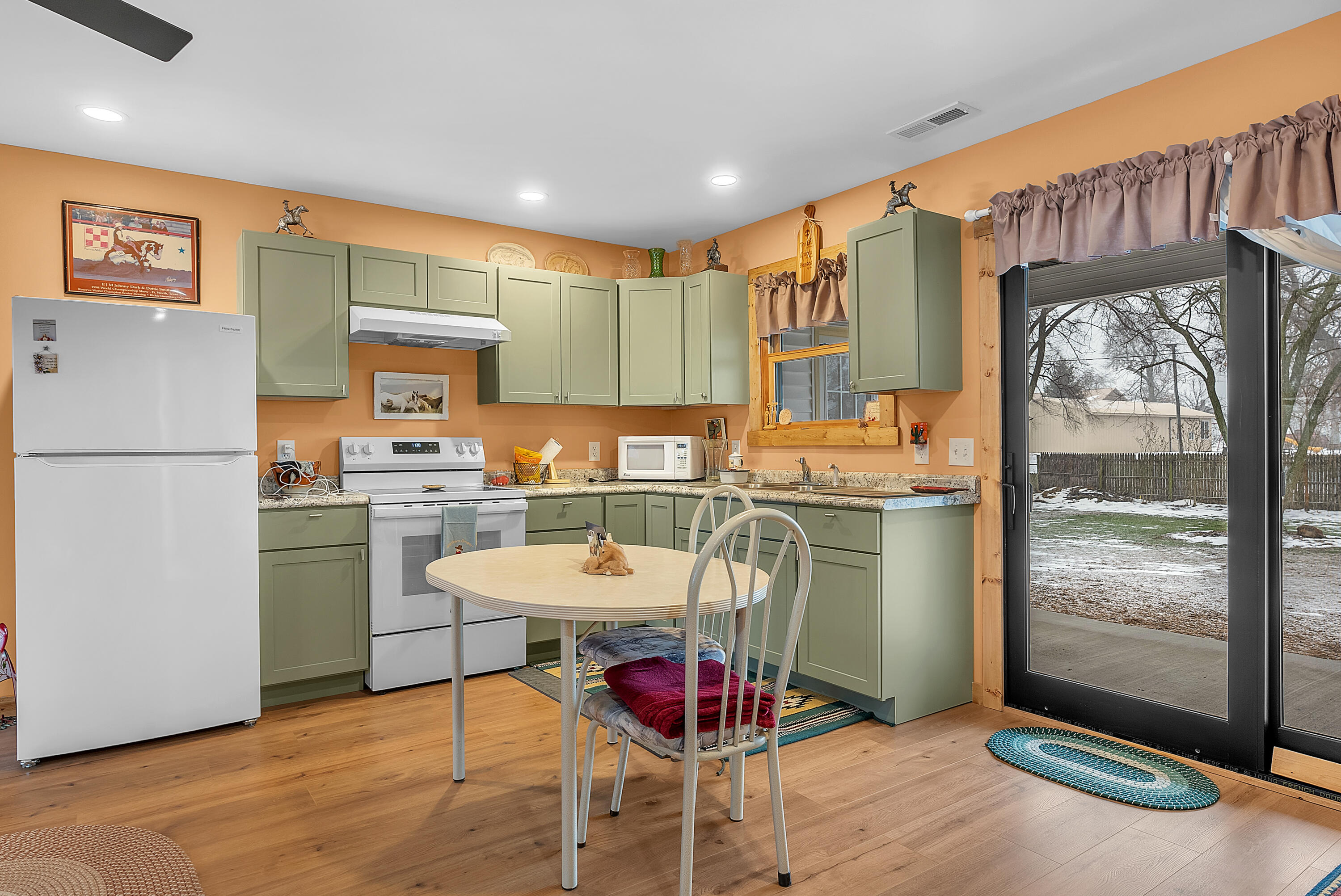 25 East Grove Street Wheatfield, IN 46392 - Photo 10 of 18 a kitchen with a refrigerator and a stove top oven