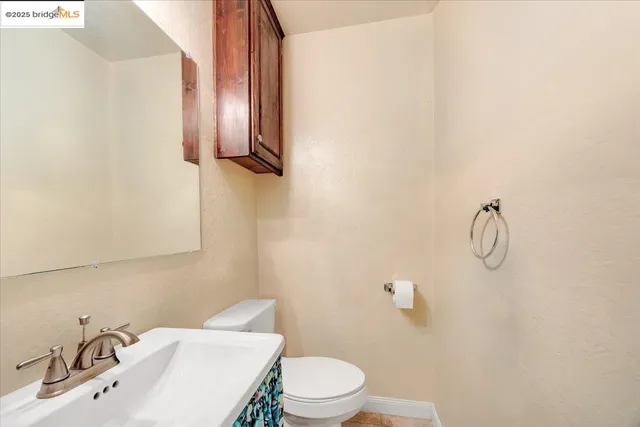 a living room with furniture and a dining table with rug