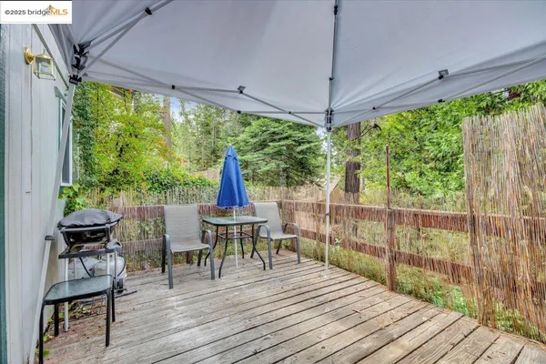 a view of a room with wooden floor and outdoor space